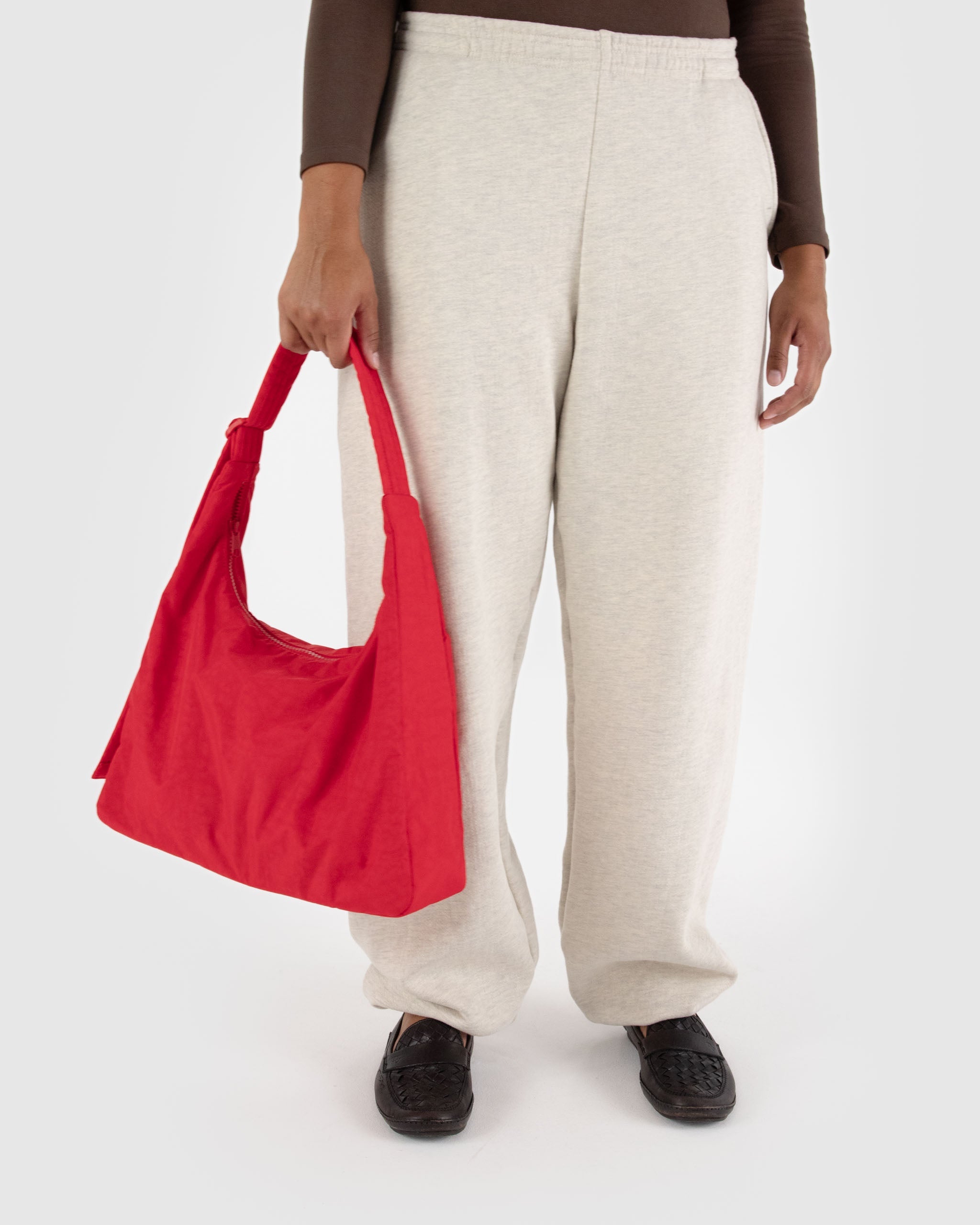 BAGGU Nylon Shoulder Bag in Candy Apple Red worn over the shoulder