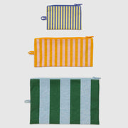 A Set of three Baggu Hotel Stripes Flat pouches laid flat