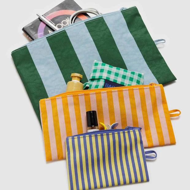 A Set of three Baggu Hotel Stripes Flat pouches shown with contents in them