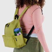 A person wearing A BAGGU medium recycled nylon backpack in Lemongrass on their back