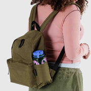 A person wearing A medium recycled nylon backpack from BAGGU in Seaweed