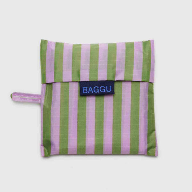 A Baggu Avocado Candy Stripe standard reusable bag in its pouch