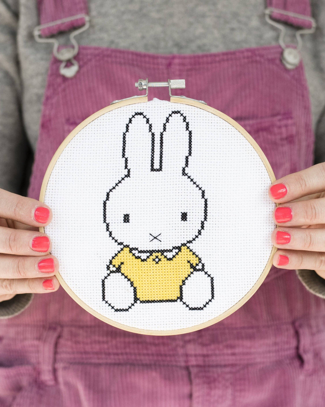 A person holding Cotton Clara yellow Miffy.