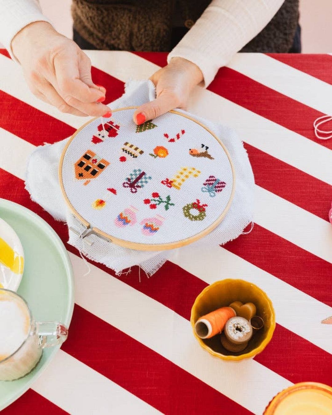 Cotton Clara Christmas-themed cross-stitch kit featuring festive colors and holiday design.