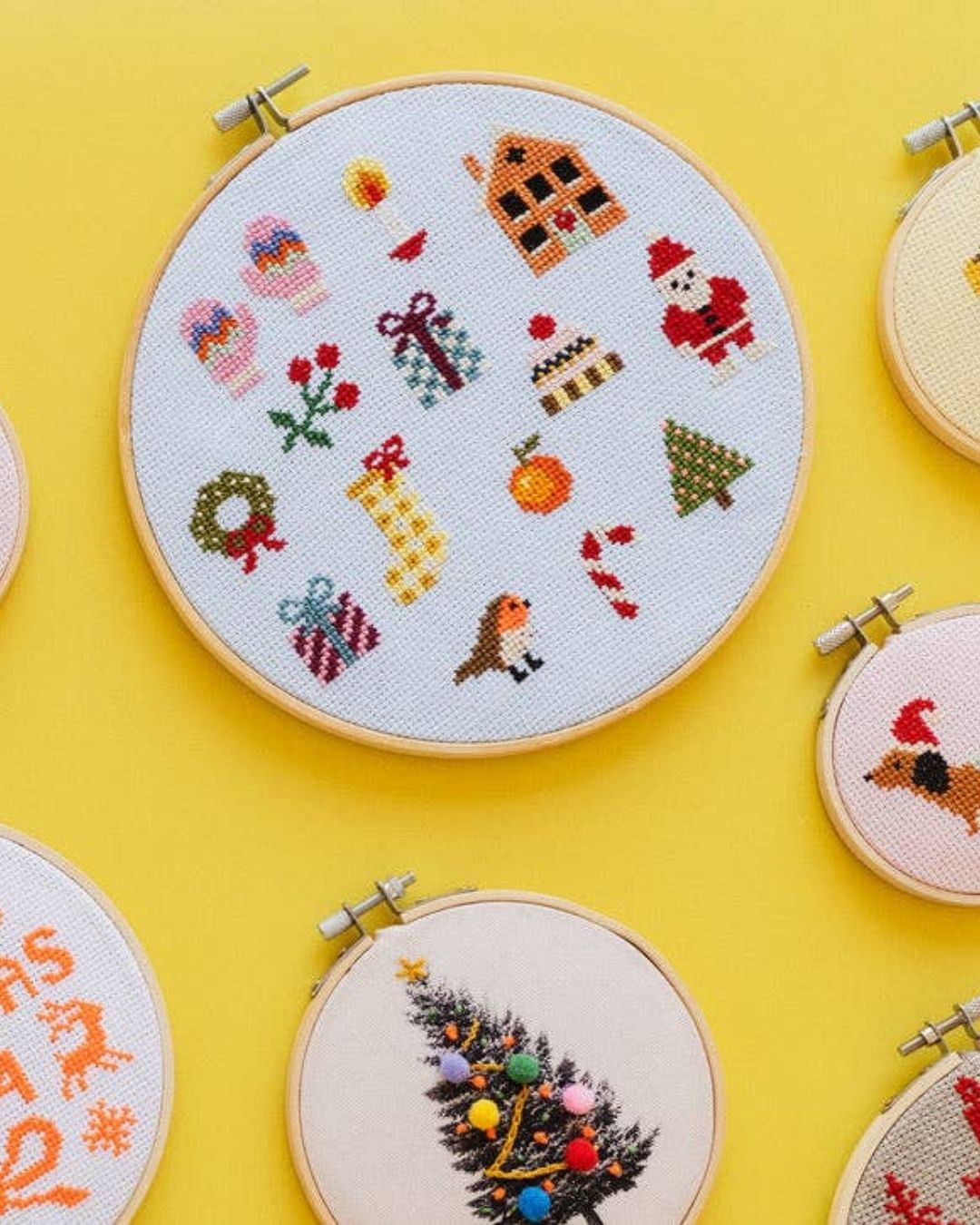 Cotton Clara Christmas-themed cross-stitch kit featuring festive colors and holiday design.