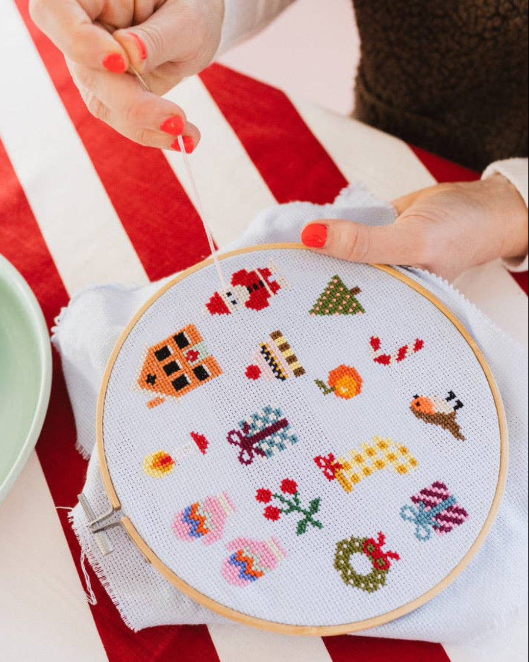 Cotton Clara Christmas-themed cross-stitch kit featuring festive colors and holiday design.
