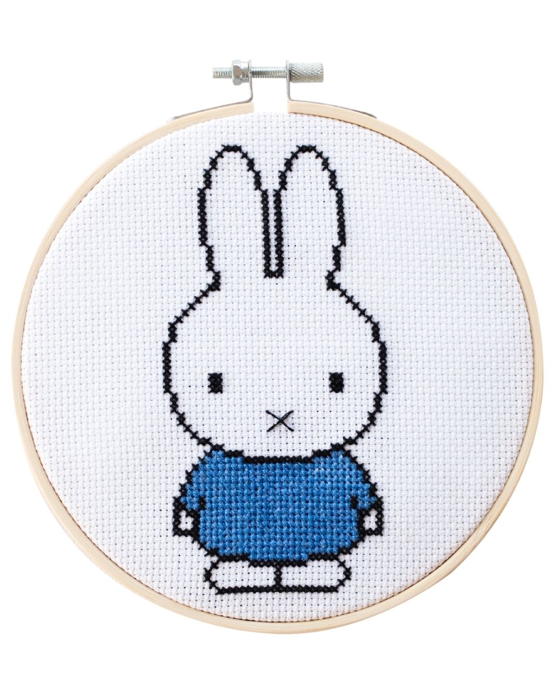 A cross-stitched blue Miffy bunny in an embroidery hoop.