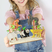 A child holding a completed Save our Animals activity box from Cotton Twist