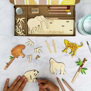 An open box with the contents of a Save our Animals activity box from Cotton Twist