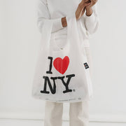 Person holding a standard BAGGU I Love NY recycled bag