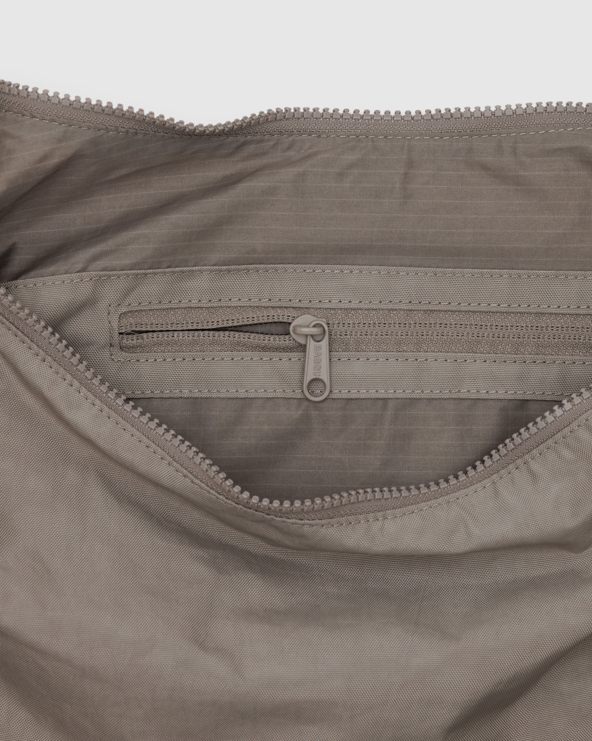 A close up of a large Crescent Bag from BAGGU in Dove