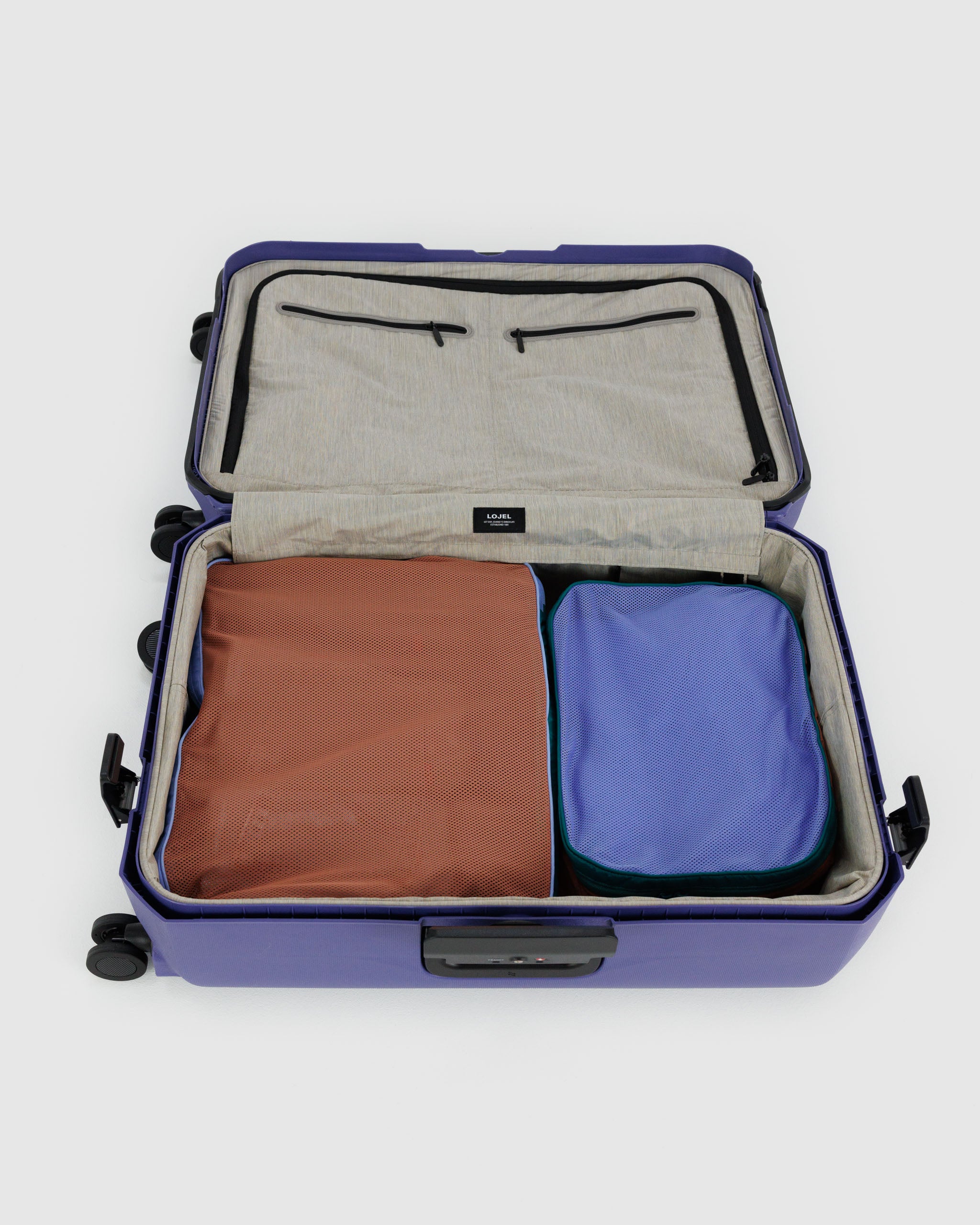 A set of large BAGGU packing cubes in Mesh Canyon shown in a suitcase