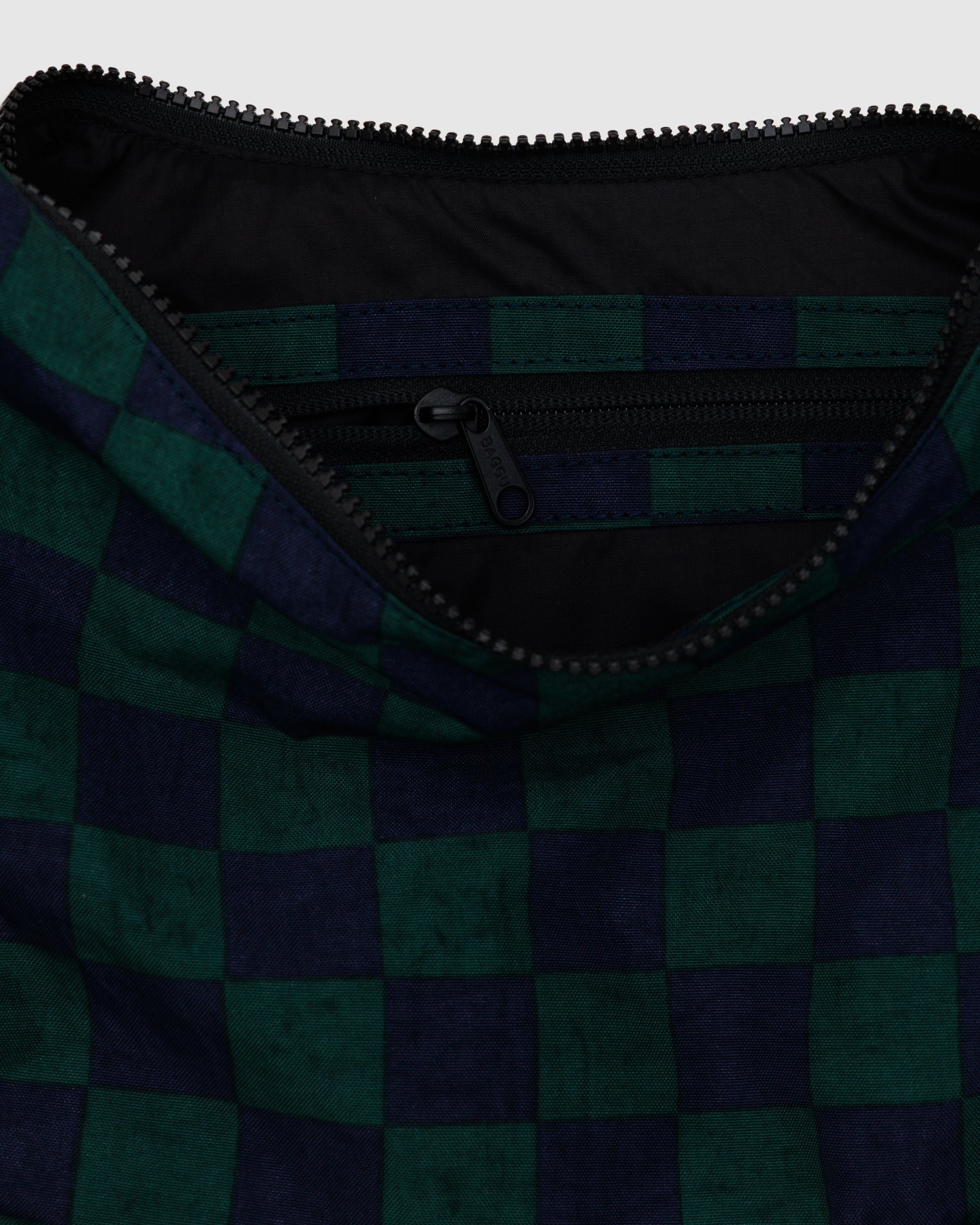 A close up of a medium Crescent Bag from BAGGU in Navy Green Check.