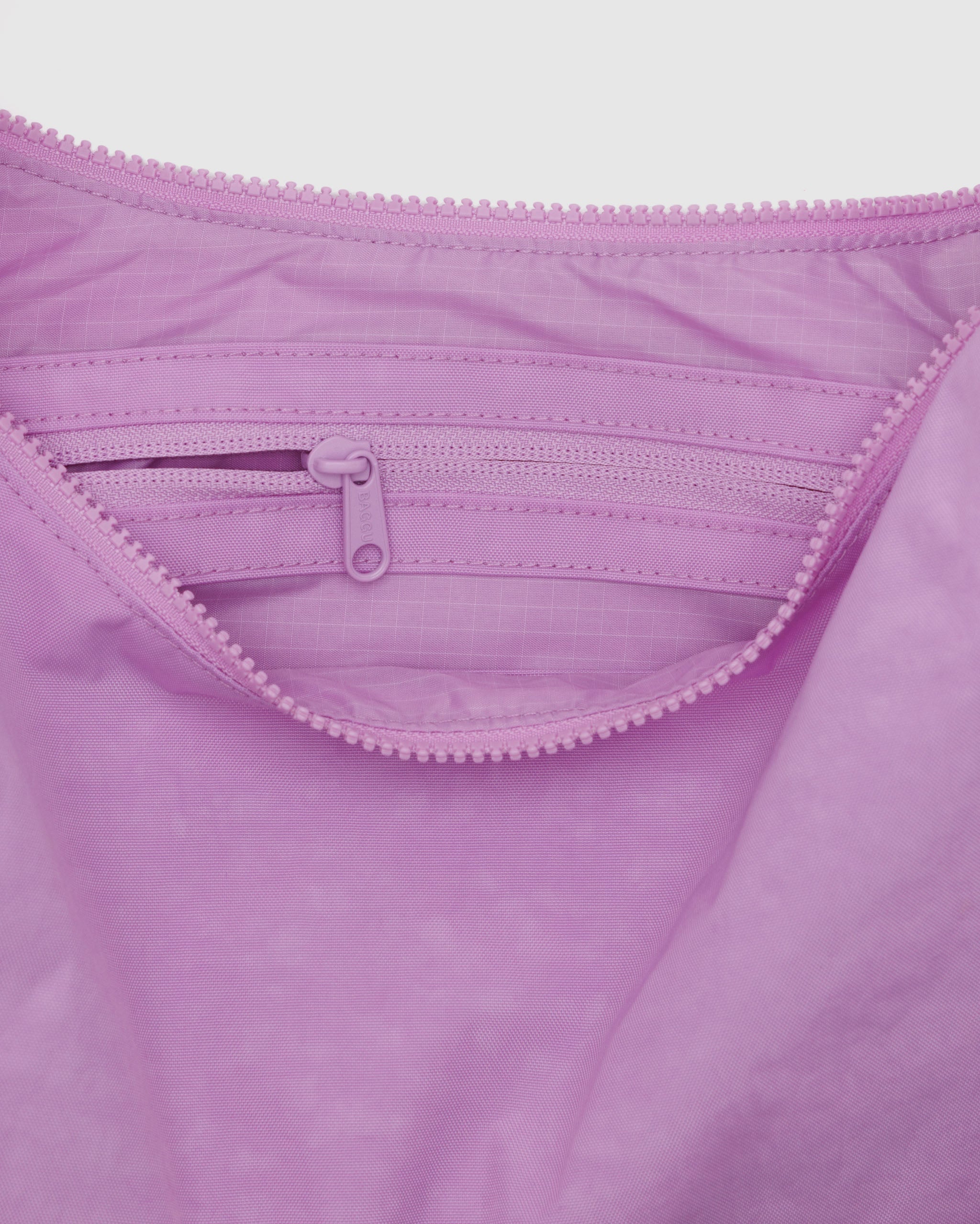 The inside of a BAGGU medium crescent bag in Peony