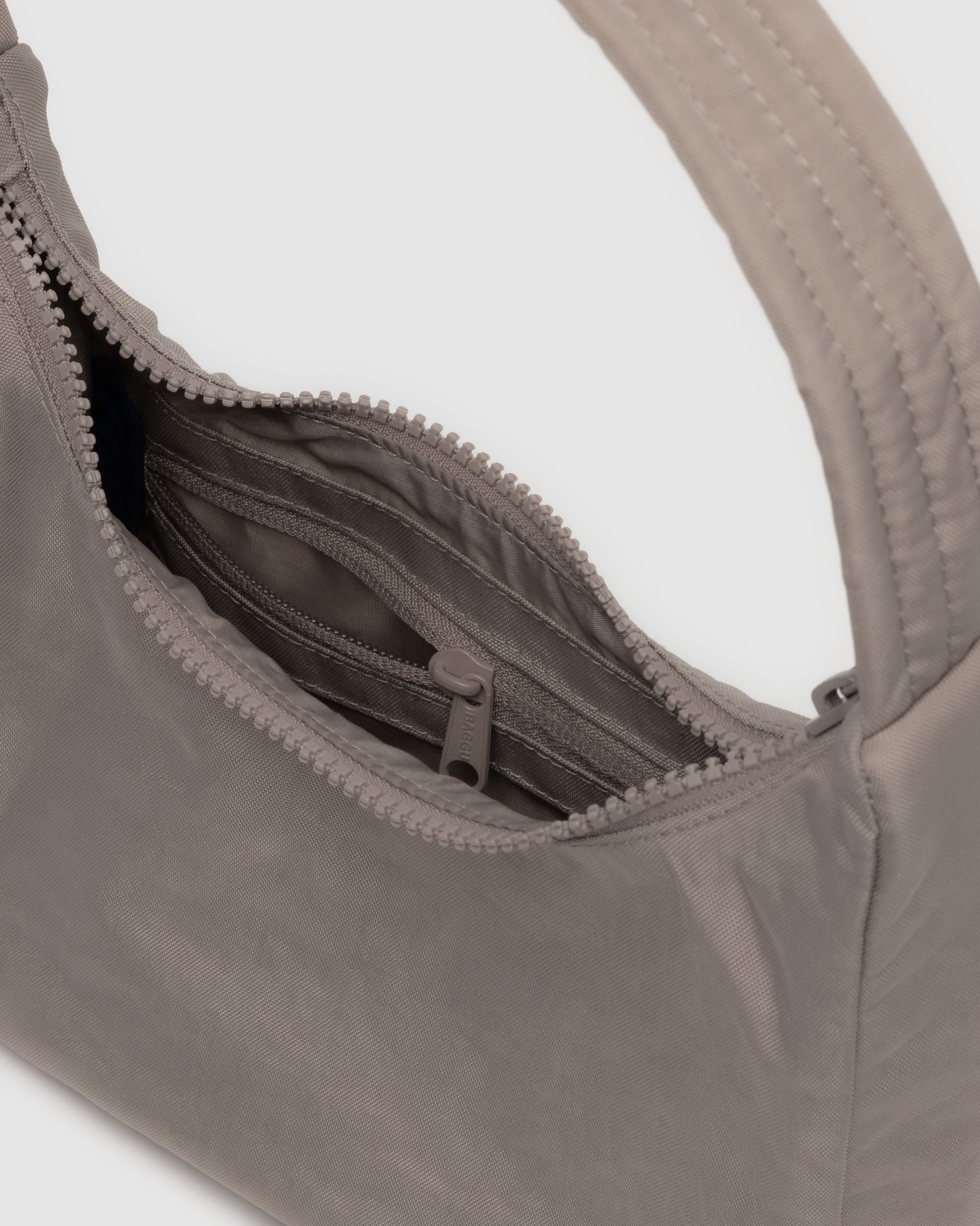 A BAGGU mini nylon shoulder bag in Dove. Made from recycled material. Machine washable 