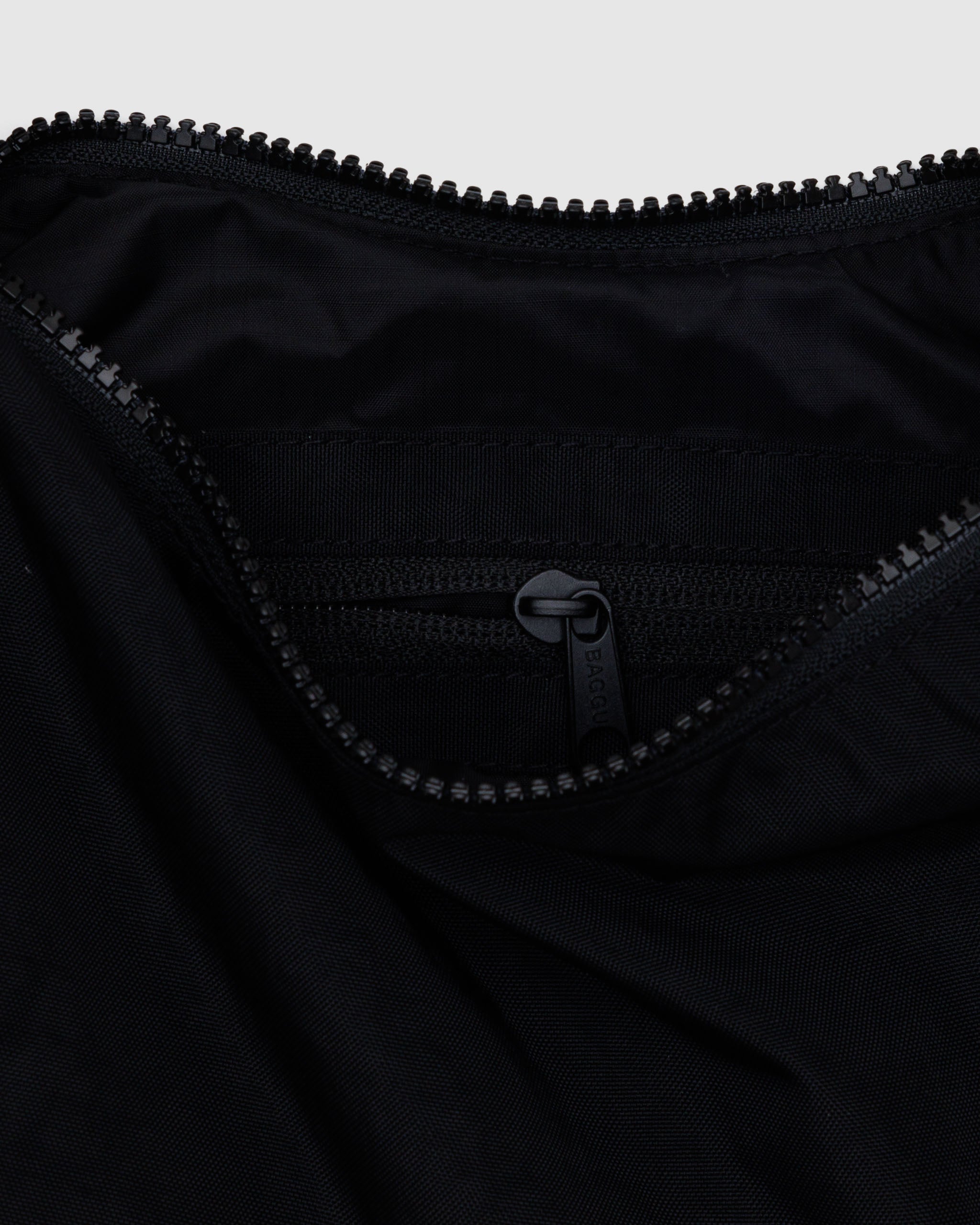 Inside zip of small Crescent Bag from Baggu in Black