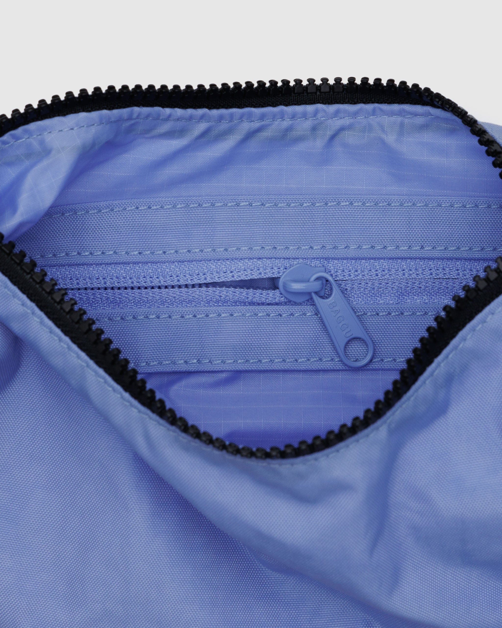 The inside of a BAGGU small crescent bag in Cornflower