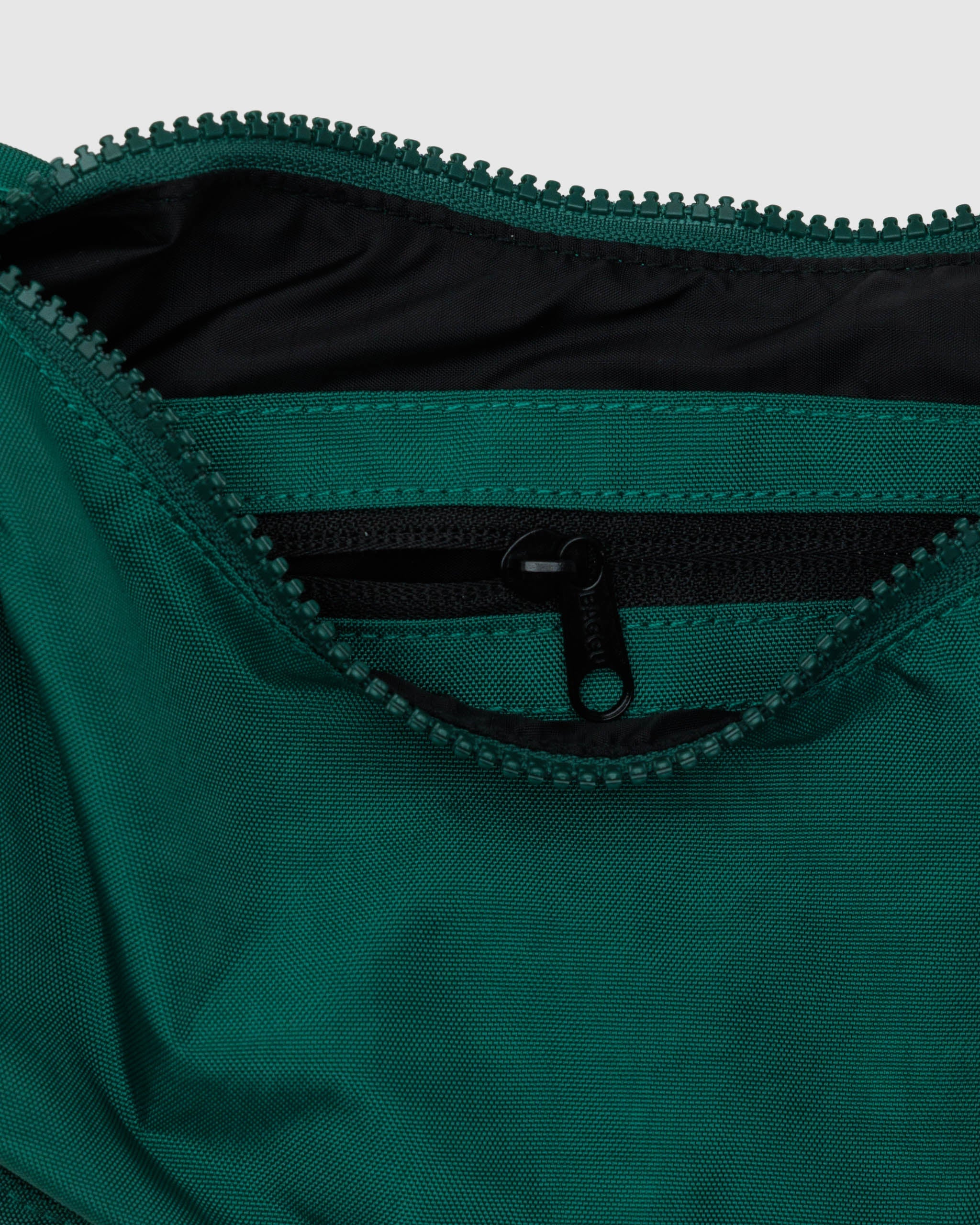 The inside of a BAGGU small crescent bag in Cypress