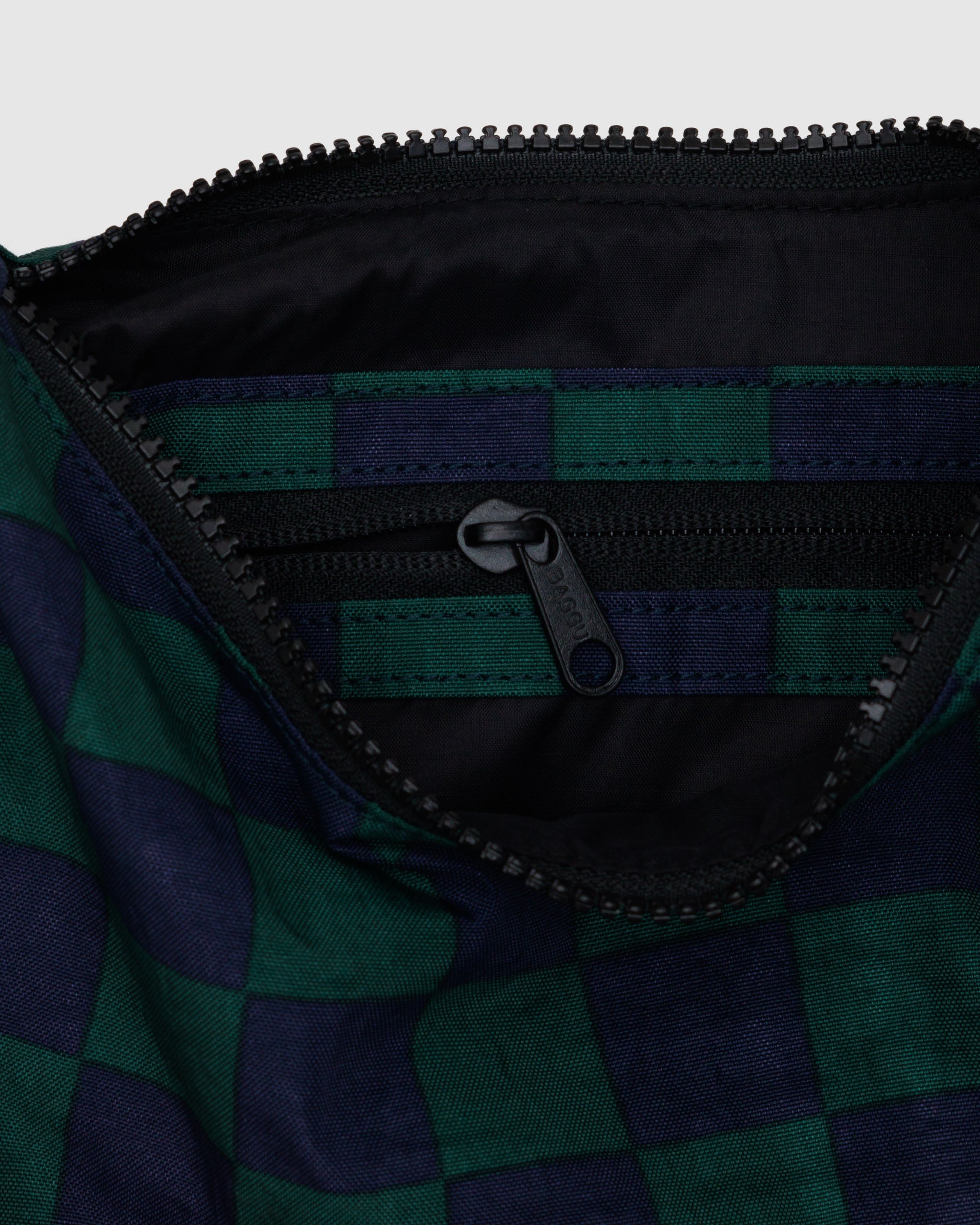 The inside of a BAGGU small crescent bag in Navy Green Check