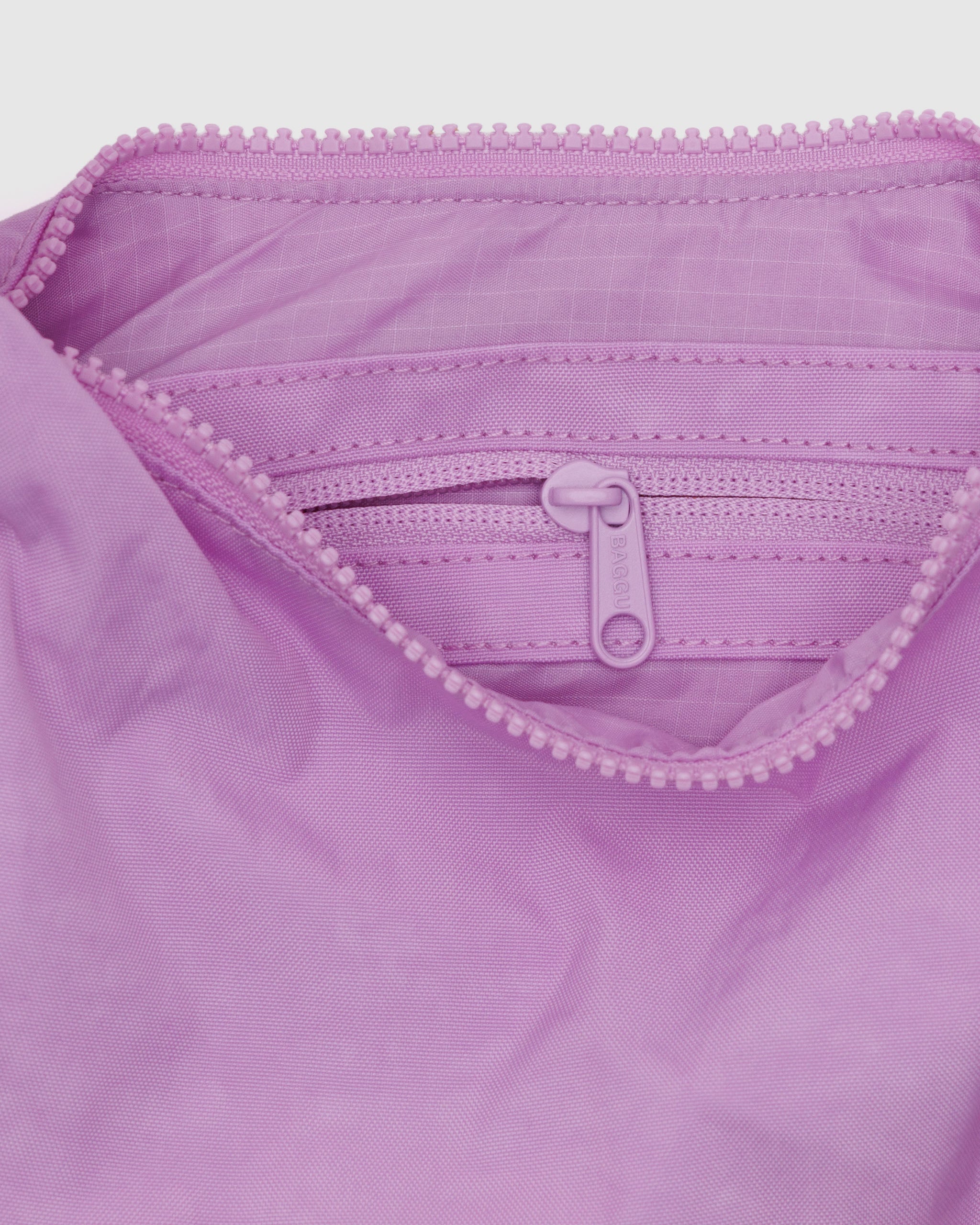 The inside of a BAGGU small crescent bag in Peony