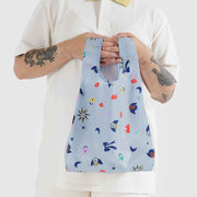 Person holding a Ditsy Charms design reusable Baby Baggu