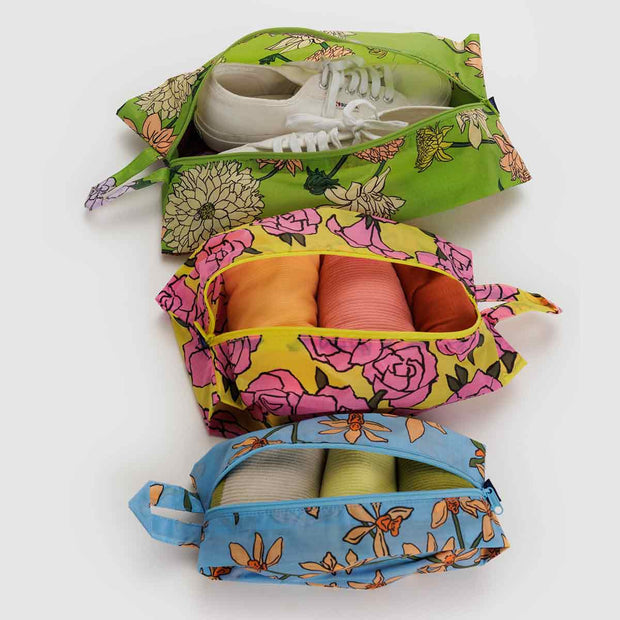 Set of three Garden Flowers 3D Zip pouches open with items in them