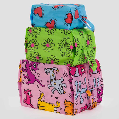 A Set of three BAGGU x Keith Haring 3D Zip pouches stacked on top of each other