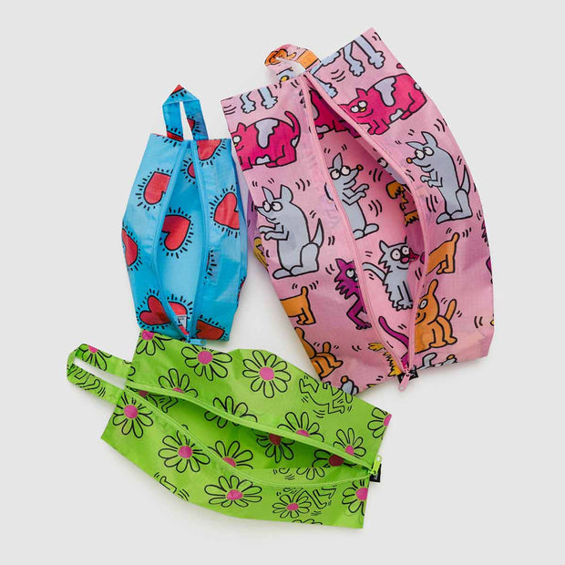 A Set of three BAGGU x Keith Haring 3D Zip pouches unzipped and empty