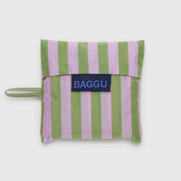 A Baby Baggu featuring the Avocado Candy Stripe design folded in its pouch