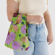 A person holding A Baby Baggu featuring the Dahlia design