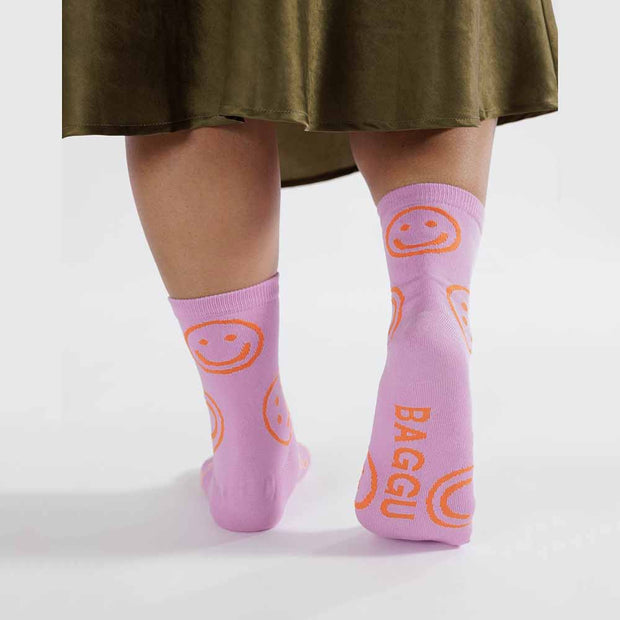 A person wearing A pair of Peony Happy Crew Socks