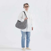person holding A large Crescent Bag from Baggu in Black & White Gingham