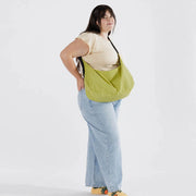 person holding A large Crescent Bag from Baggu in Lemongrass