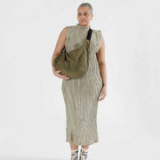 Woman holding A large Crescent Bag from Baggu in Seaweed