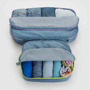 A set of open Baggu Digital Denim large packing cubes containing clothes 