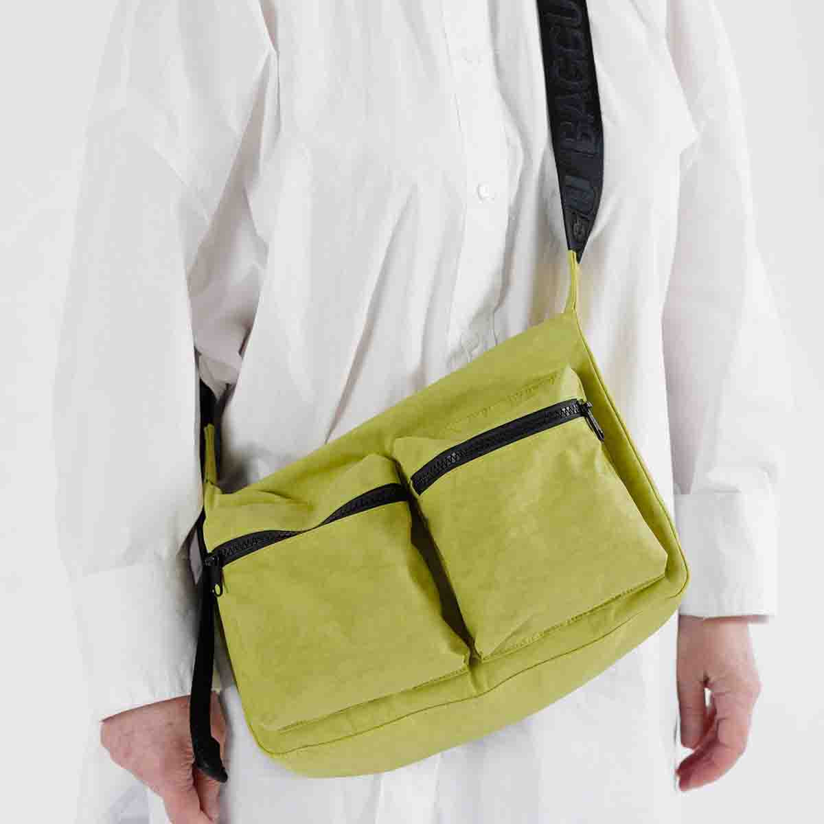 Person wearing a Baggu Lemongrass Medium Cargo Crossbody bag 