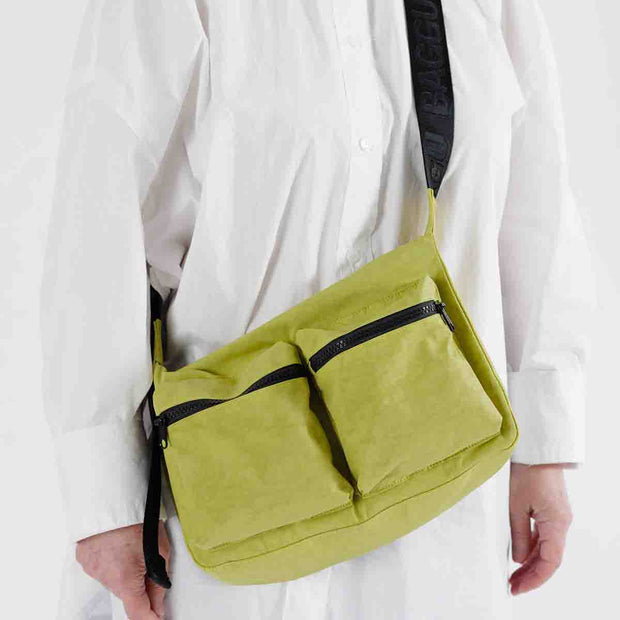 Person wearing a Baggu Lemongrass Medium Cargo Crossbody bag 