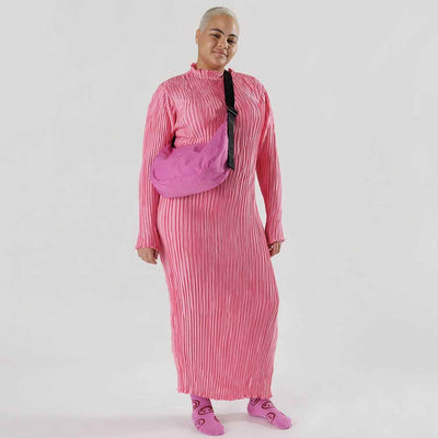 A person wearing A medium Crescent Bag from Baggu in Extra Pink