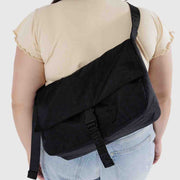 A Baggu Recycled Nylon Messenger Bag in Black worn crossbody