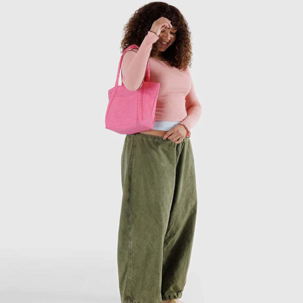 Woman with Baggu Mini Cloud Bag in Azelea Pink over her shoulder