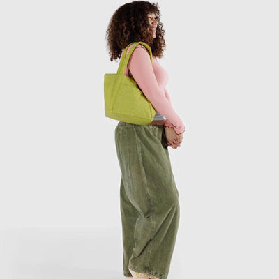 Baggu Lemongrass Mini Cloud Bag worn over woman's shoulder
