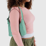 close up shot of woman holding Baggu Mini Nylon Shoulder Bag in Green Gingham