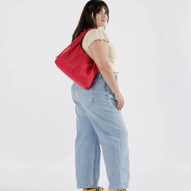 Person holding A Candy Apple recycled nylon Shoulder Bag from Baggu