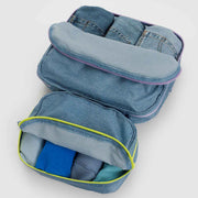 A set of two Baggu Digital Denim Packing Cubes shown open with clothes in them