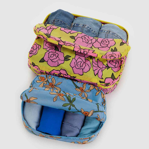 A set of two Baggu Garden Flowers Packing Cubes shown open with clothes in them