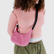 A small Baggu Crescent Bag in Azalea Pink worn crossbody