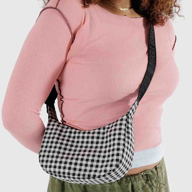 Person with A small Baggu Crescent Bag in Black & White Gingham worn crossbody 
