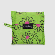 A Baggu Keith Haring Flowers standard reusable and recycled bag in its pouch