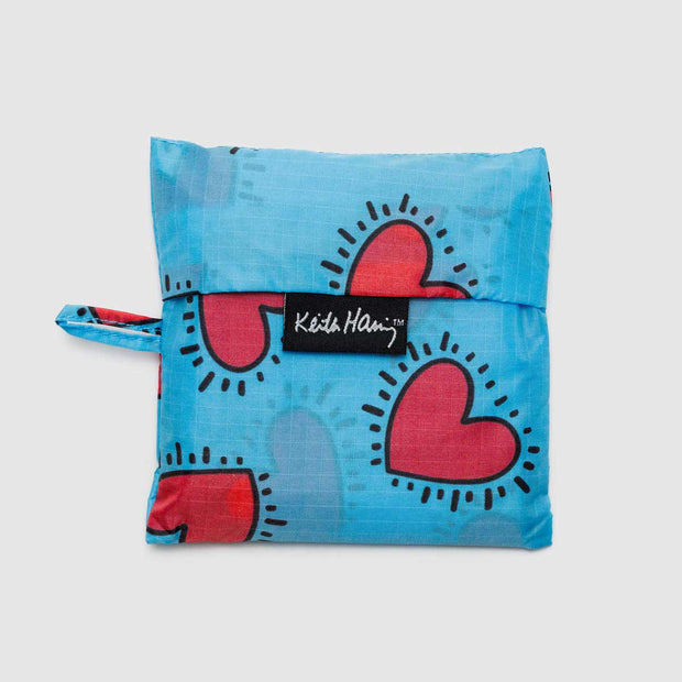 A Keith Haring Hearts Standard Baggu in its pouch