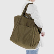 Person with Baggu Travel Cloud bag in Seaweed over their shoulder